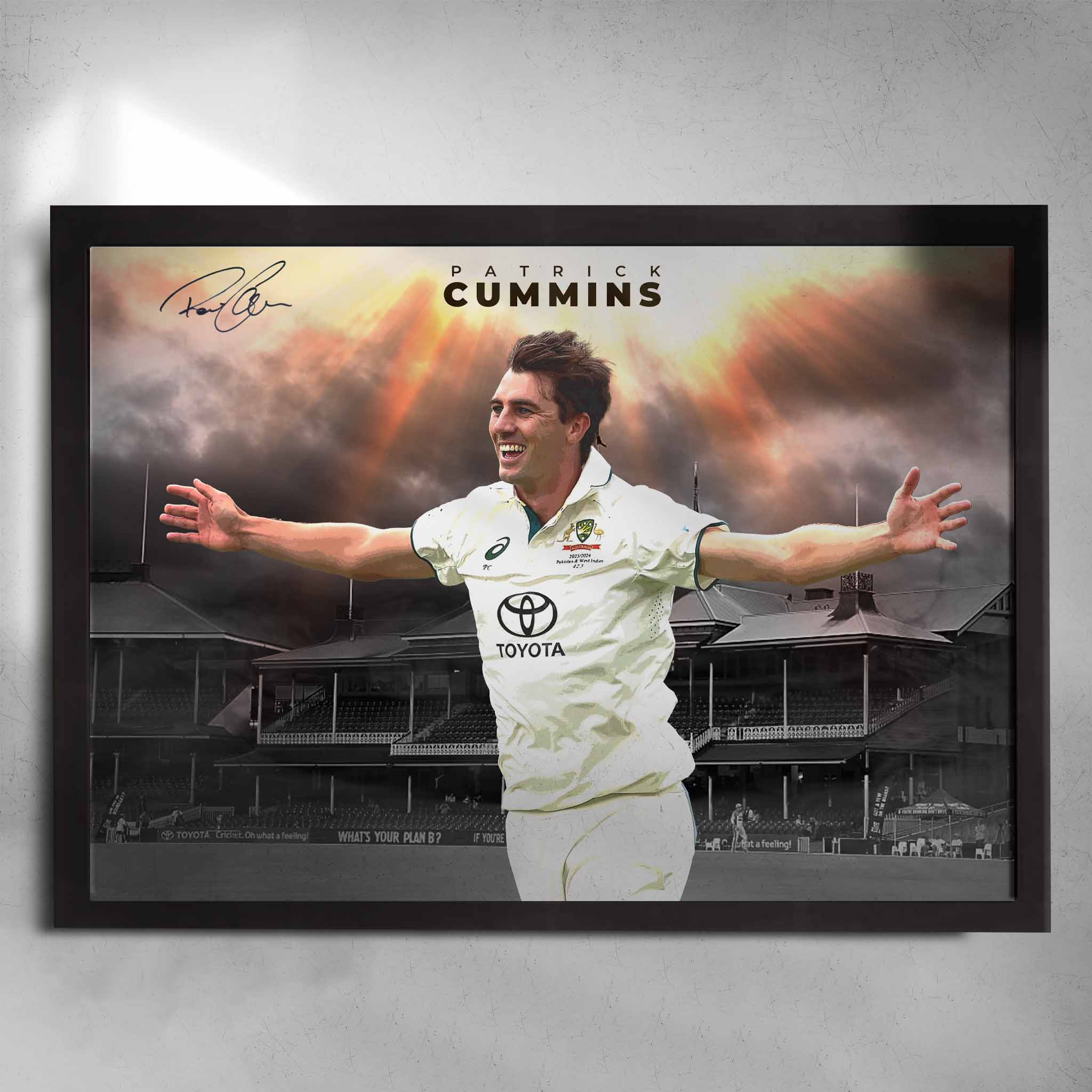Framed Pat Cummins wall art featuring him celebrating in Australian whites at the SCG with dramatic skies and signature.