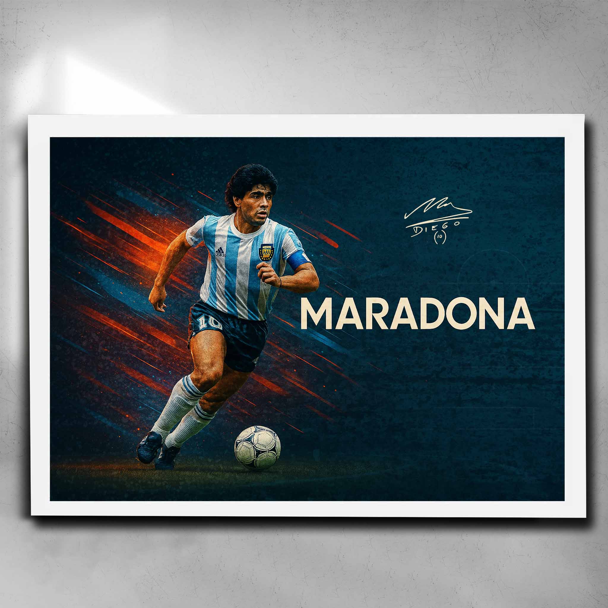 White framed soccer art featuring a signed print of the legendary Diego Maradona playing for Argentina - Artwork by Sports Cave.