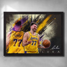 Framed Luka Dončić Lakers wall art featuring #77 jersey in yellow, dynamic brushstroke background, and confident celebration pose.