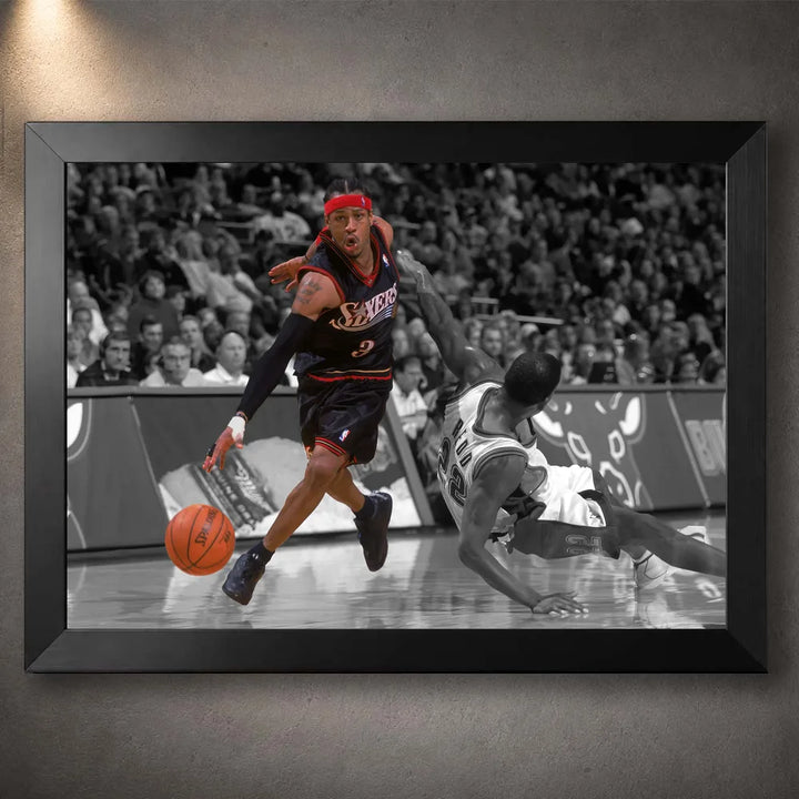 Black framed Allen Iverson basketball wall art showing a crossover against a fallen defender on court.