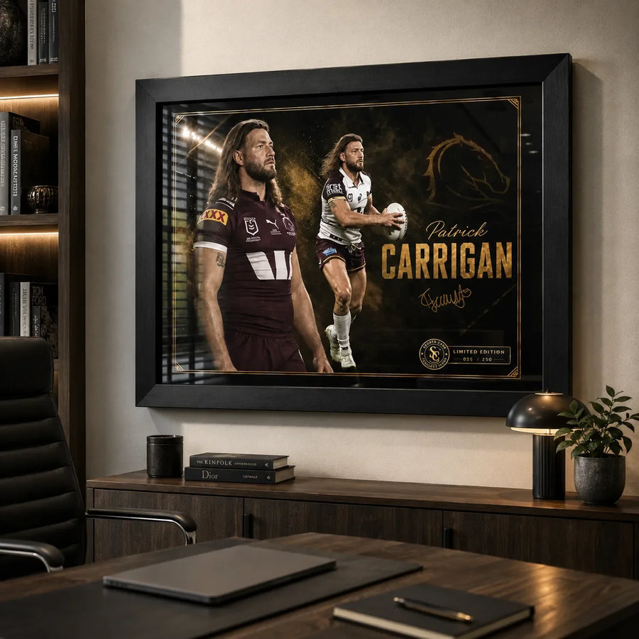 Patrick Carrigan Brisbane Broncos wall art in a modern office, displayed in a black frame above a timber credenza