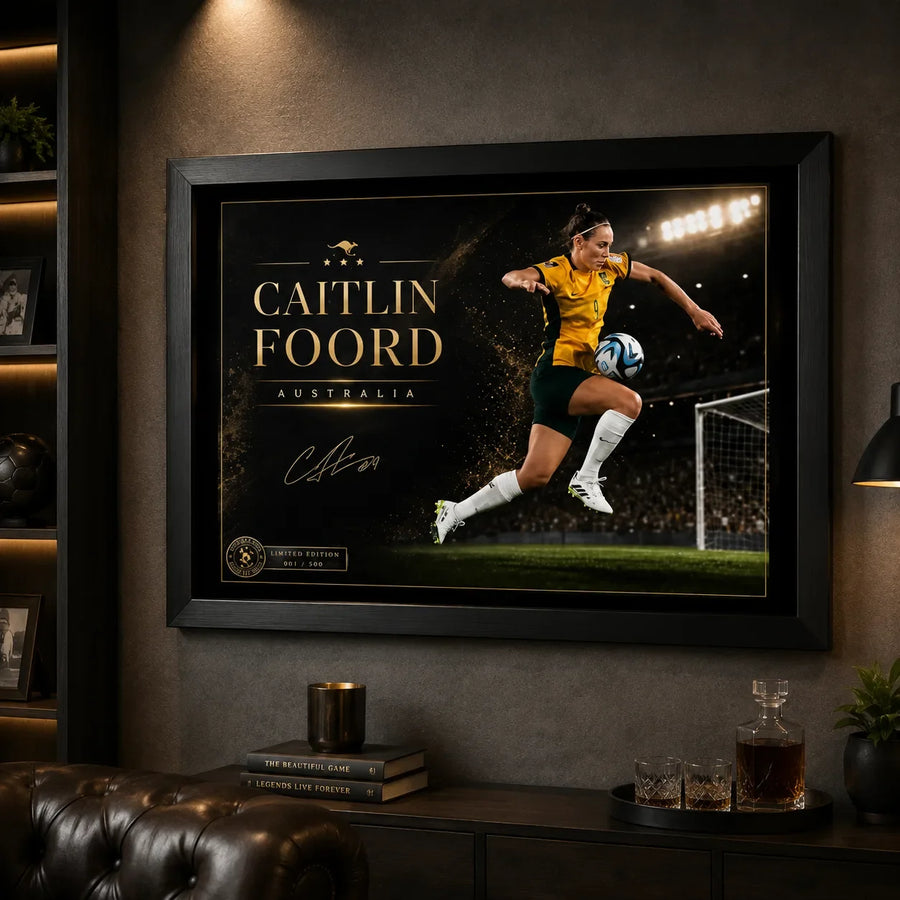 Caitlin Foord soccer wall art in a black frame displayed in a dark man cave with sports shelving and lounge seating.