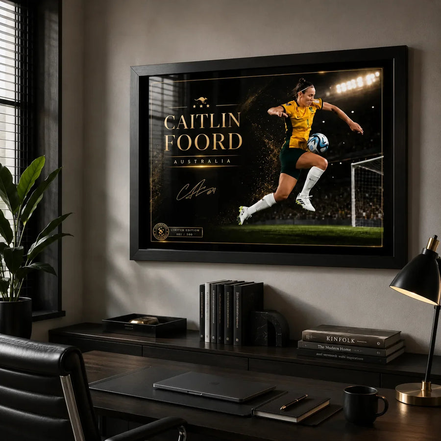 Caitlin Foord soccer wall art in a black frame displayed above a desk in a modern home office.