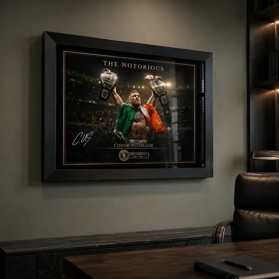 Conor McGregor wall art displayed in a refined home office above a stone console beside a black executive chair.