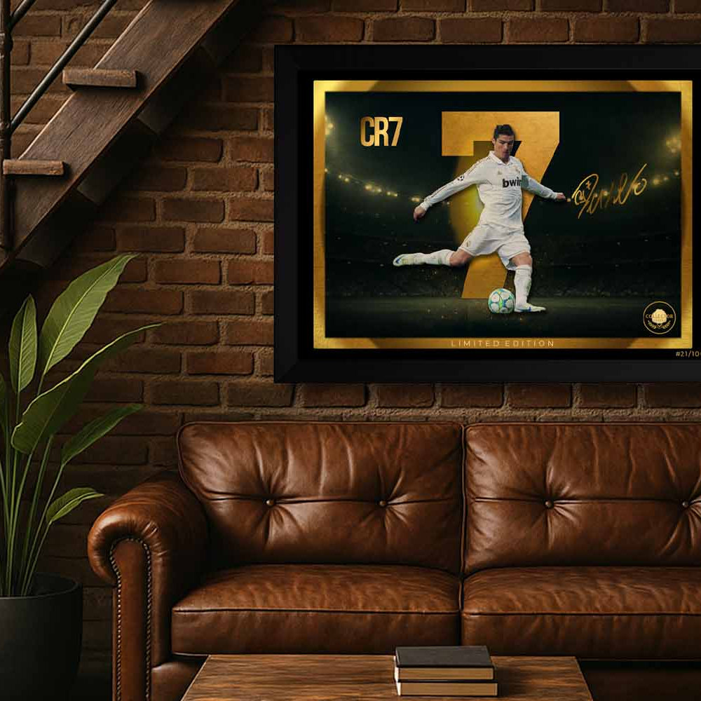 CR7 wall art framed in black, displayed above a leather sofa in a man cave setting — part of a premium limited edition sports collectible series.