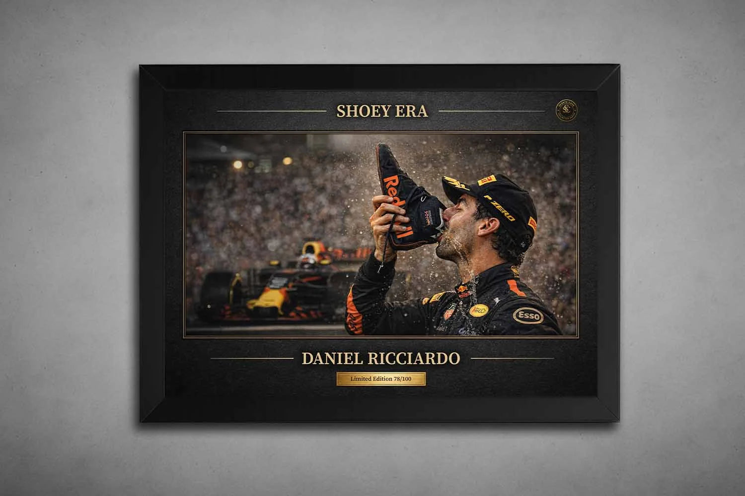 Black framed Daniel Ricciardo Shoey Era podium print with Red Bull car backdrop, premium sports collectibles display.
