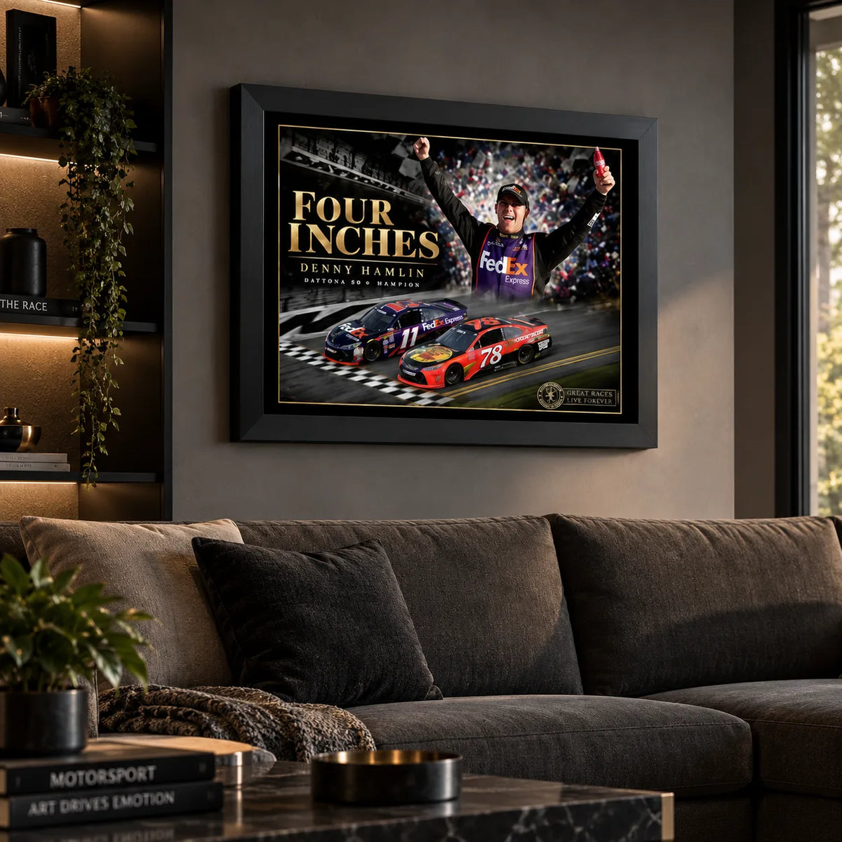 Denny Hamlin Daytona 500 racing artwork displayed above a charcoal sofa in a contemporary living room.