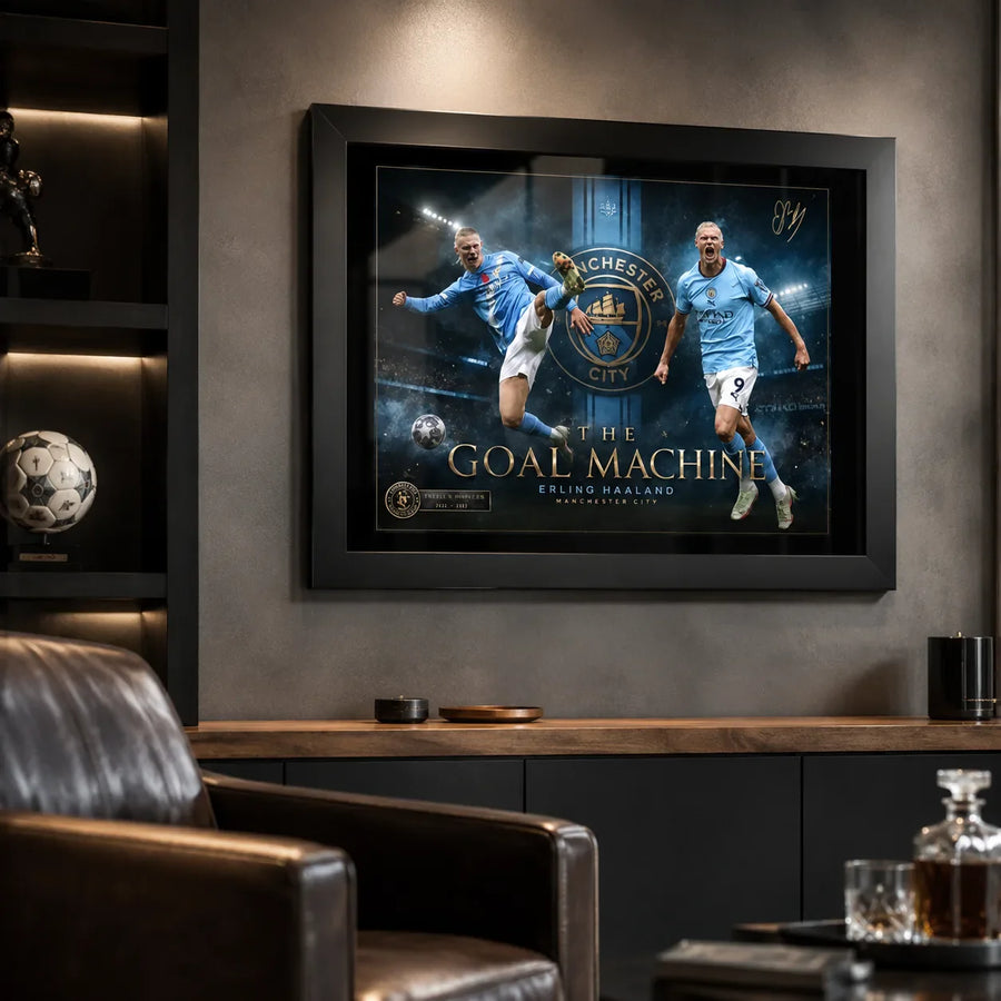Black framed Erling Haaland Manchester City wall art shown in a dark man cave with sports memorabilia.