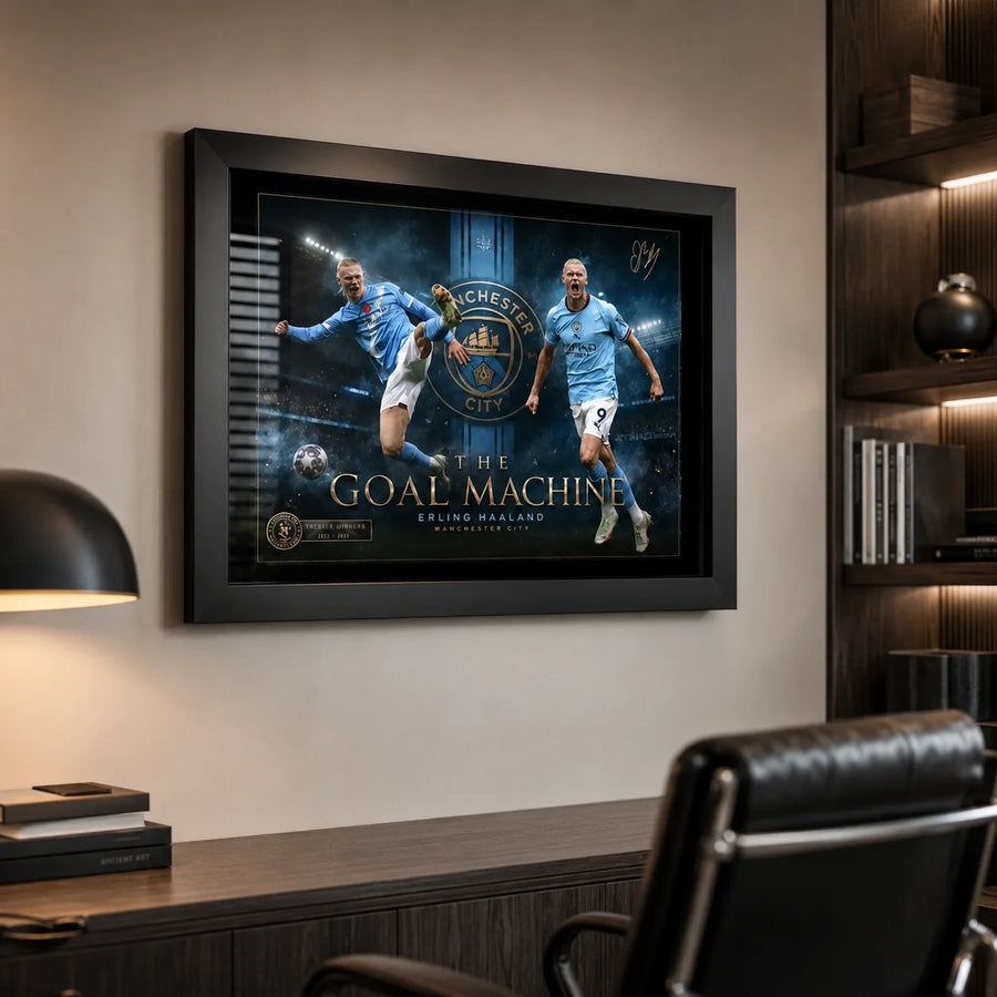 Erling Haaland Manchester City wall art in a black frame displayed in a modern office with shelving.