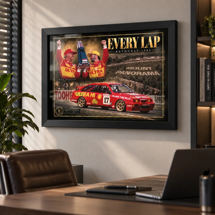 Every Lap Dick Johnson and John Bowe motorsport wall art in a modern office, shown in a black frame above the desk.
