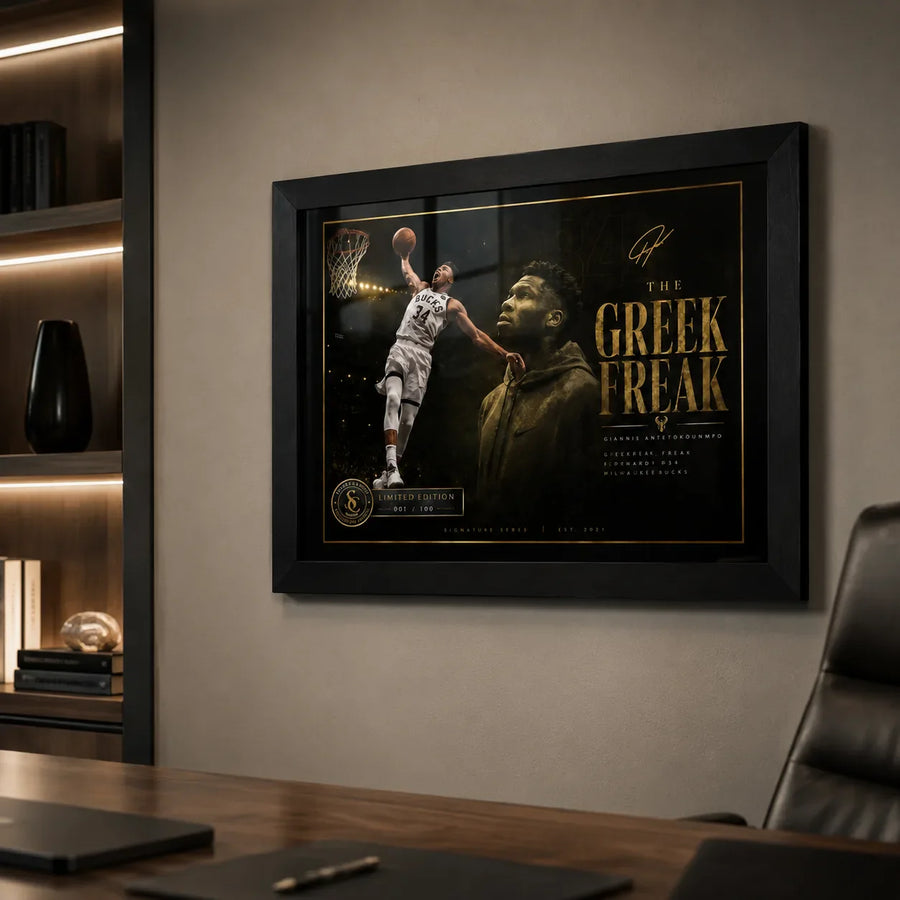 Giannis Antetokounmpo Greek Freak wall art in a black frame displayed on a modern office wall.