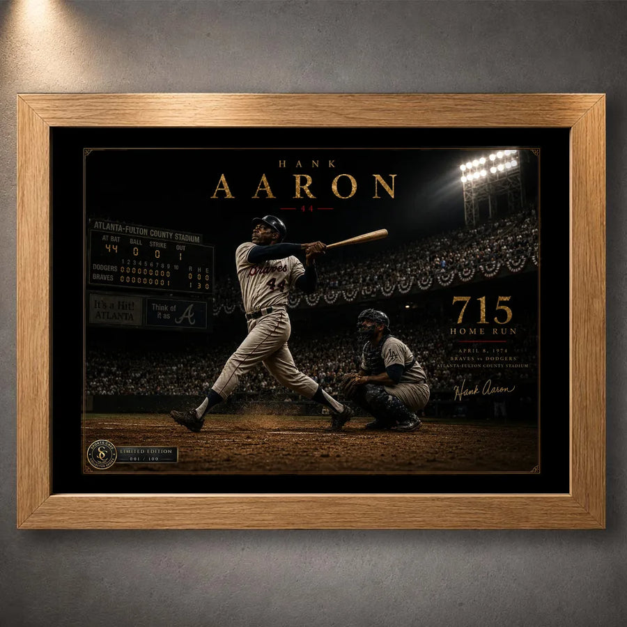 Hank Aaron 715th home run baseball wall art presented in a natural oak frame against a textured gallery wall.