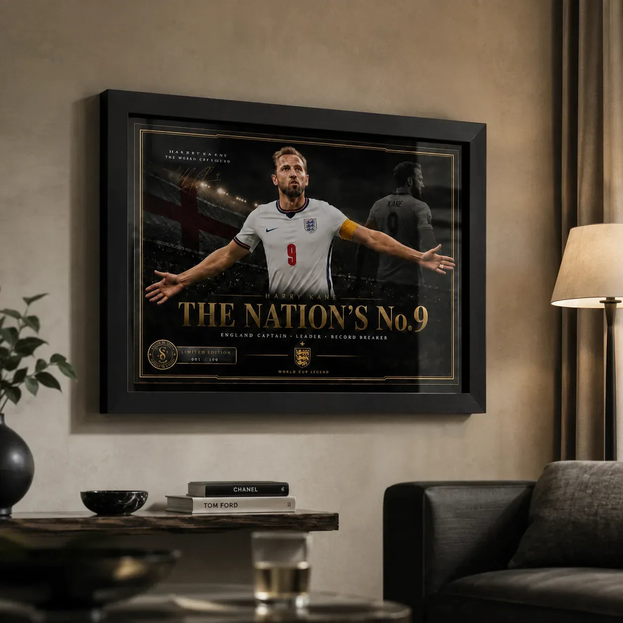 Harry Kane wall art in a black frame displayed on a warm neutral living room wall beside a lamp and sofa.