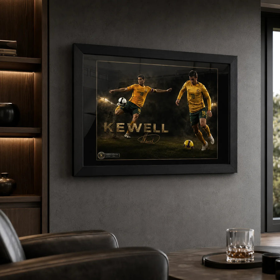 Black framed Harry Kewell soccer wall art displayed in a dark man cave with leather seating and illuminated shelving.