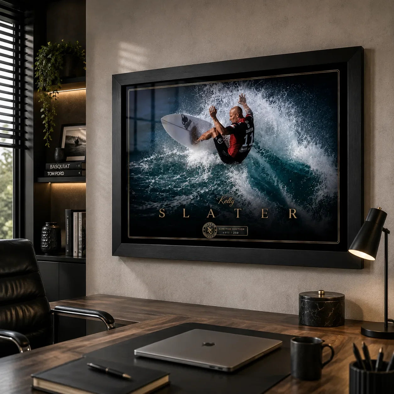 Kelly Slater surfing wall art in a black frame displayed above a timber desk in a modern office.