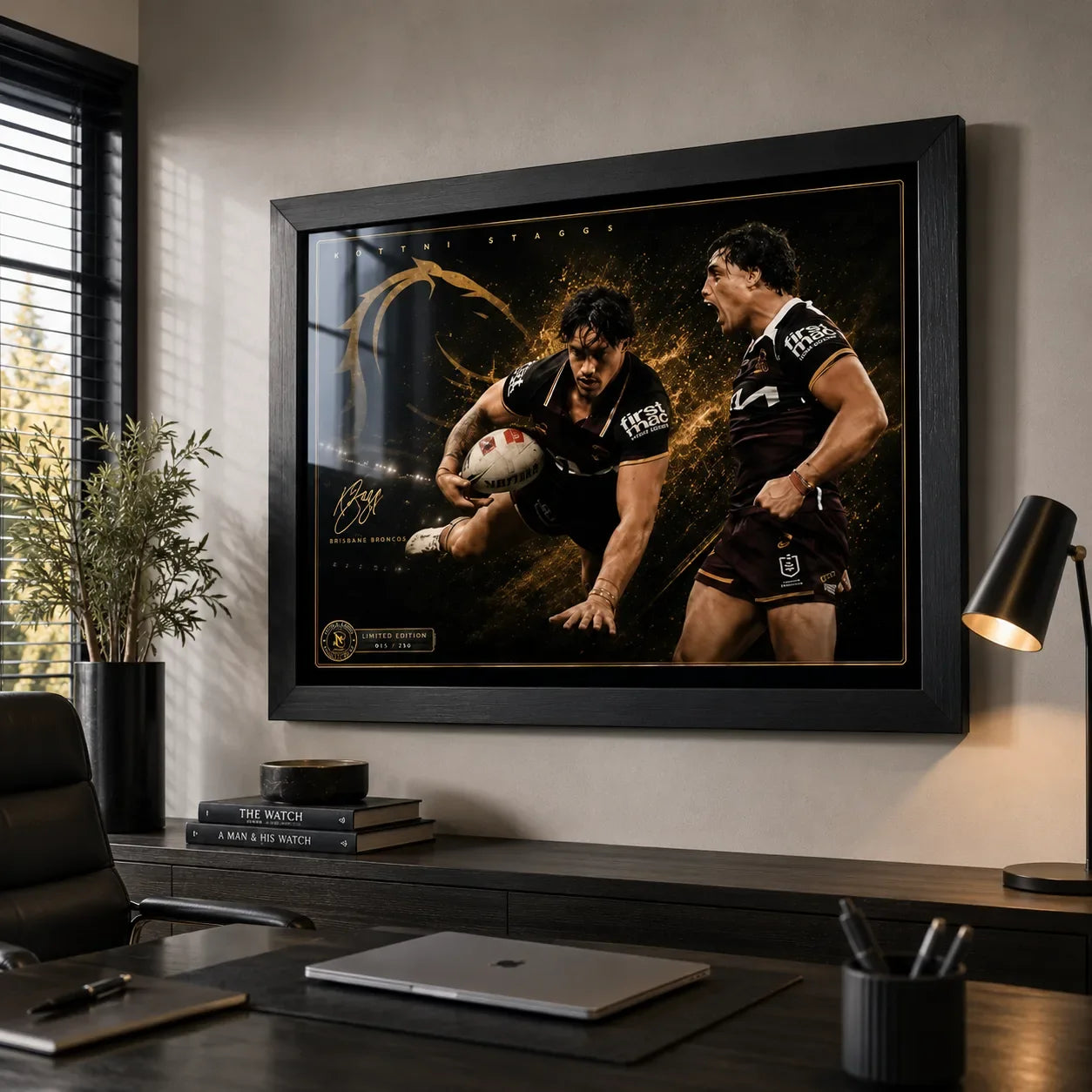 Kotoni Staggs Brisbane Broncos rugby league wall art in a black frame above a credenza in a modern office with a timber desk.