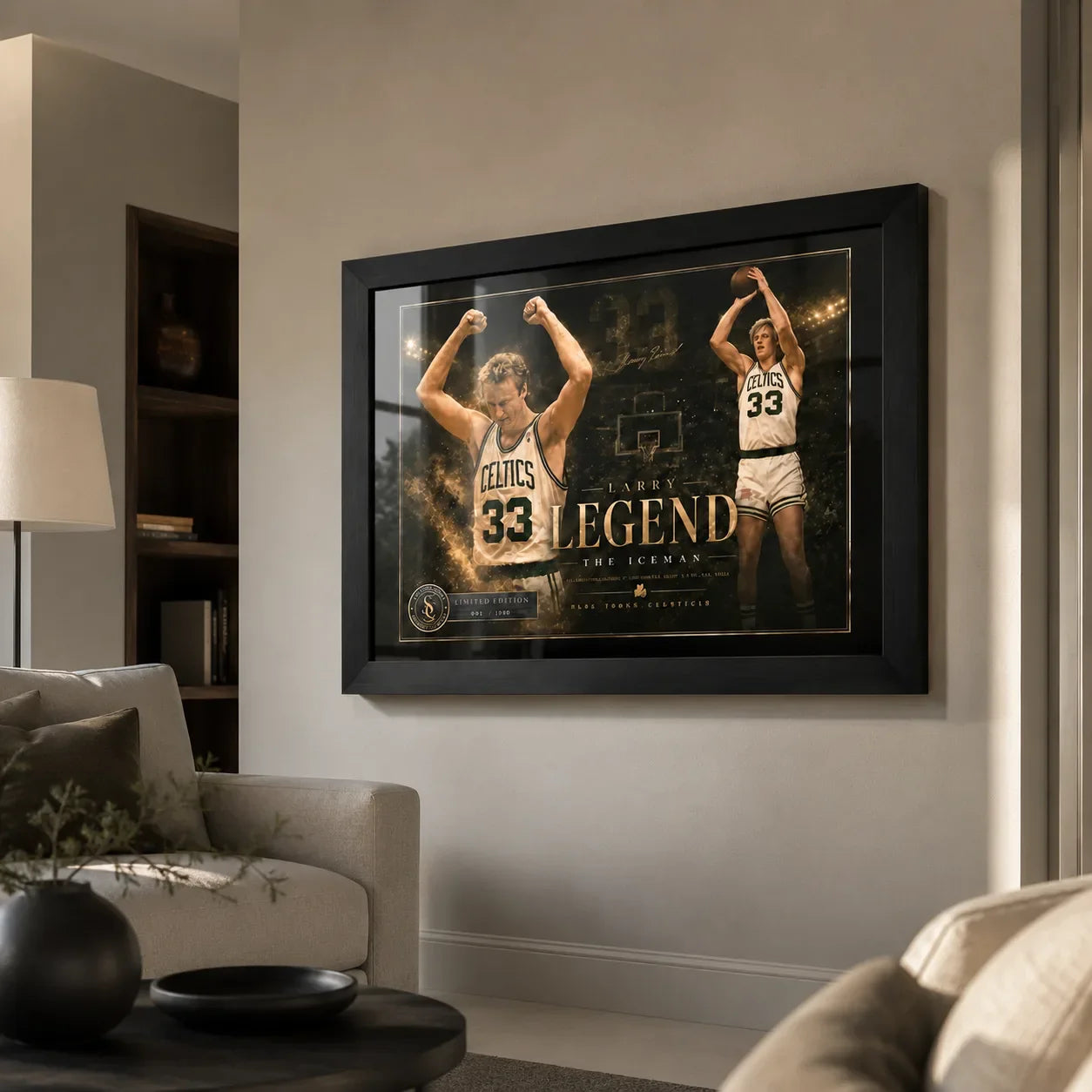 Larry Bird wall art in black frame displayed in a premium living room above a neutral sofa and warm wall.