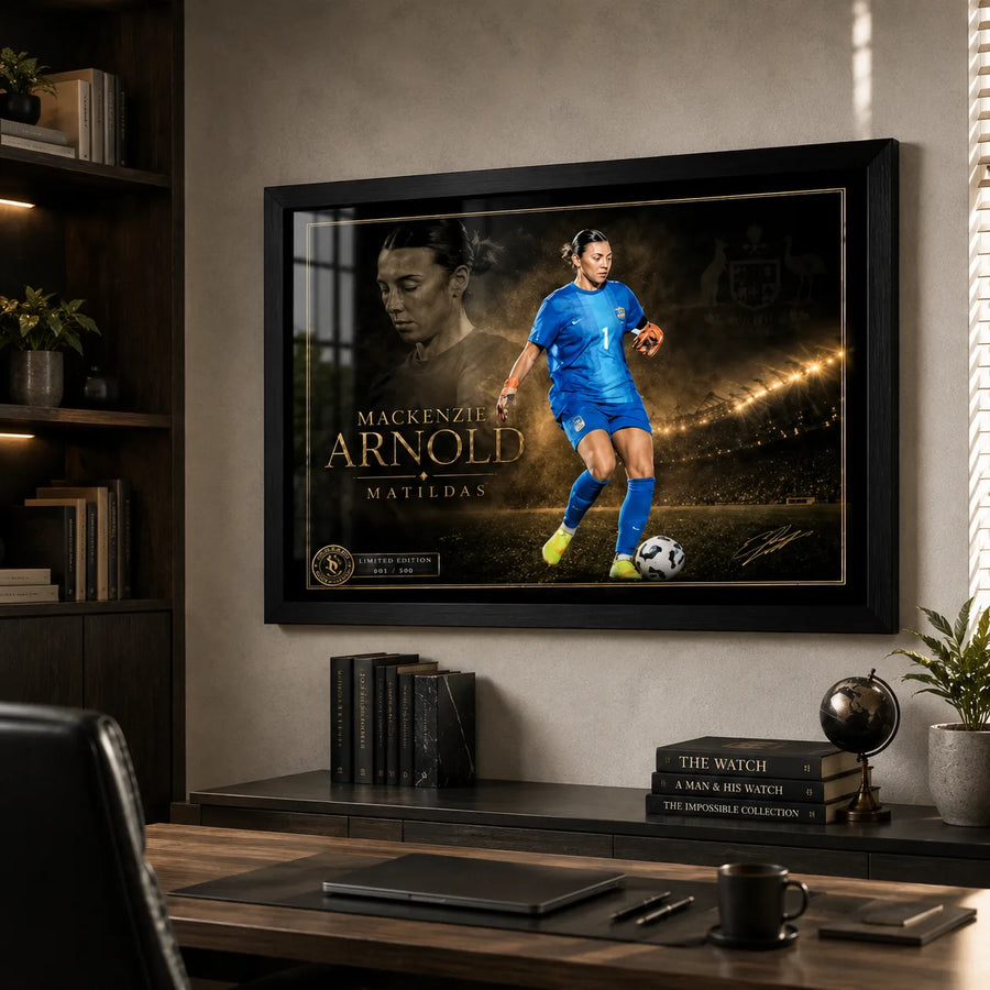 Mackenzie Arnold Matilda's sports wall art in a black frame displayed above a desk in a modern home office.