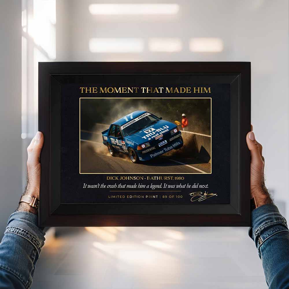 man holding a framed piece of dick Johnson crash by Sports Cave.