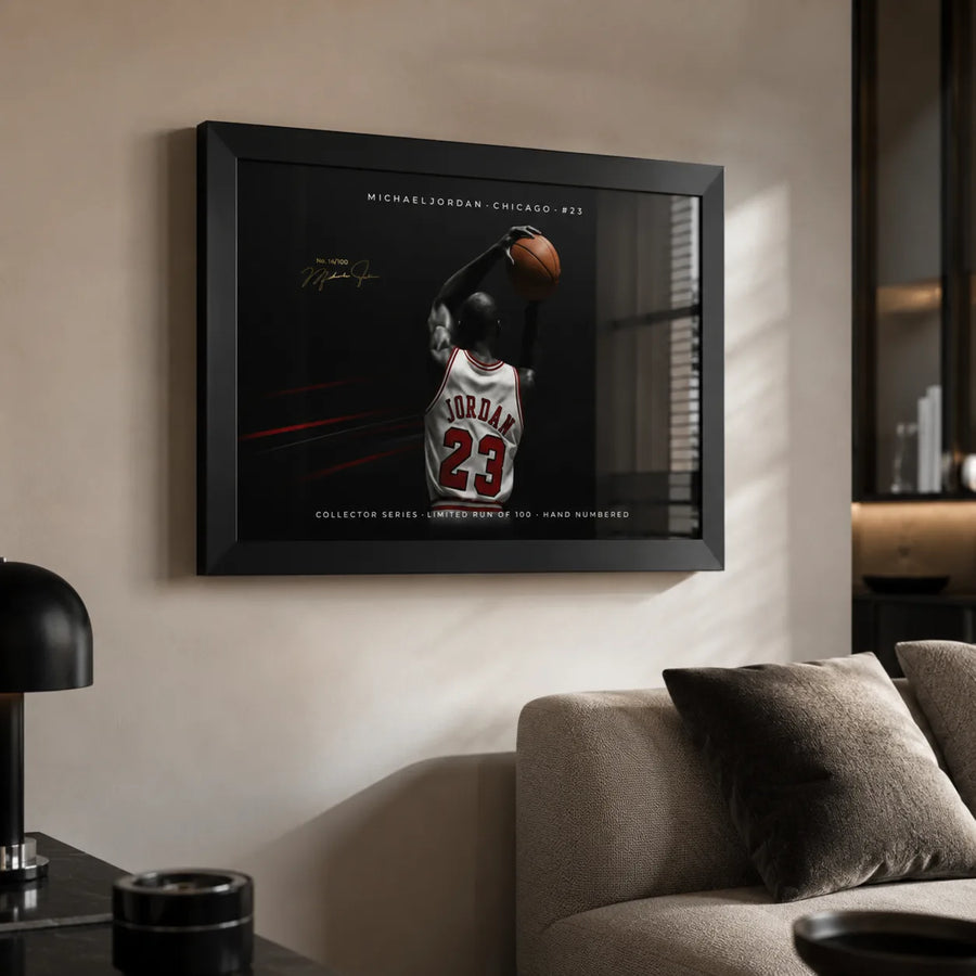 Black framed Michael Jordan basketball wall art displayed in a modern living room above a sofa.