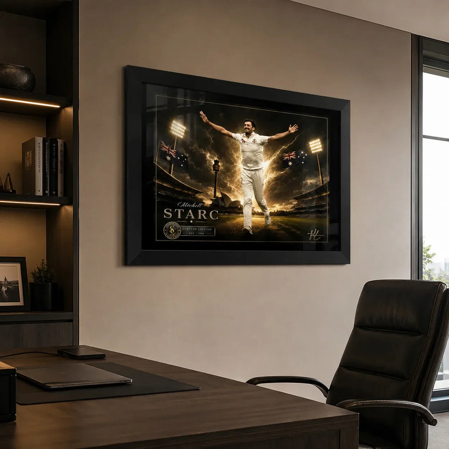 Black framed Mitchell Starc cricket wall art displayed above a desk in a refined modern office.