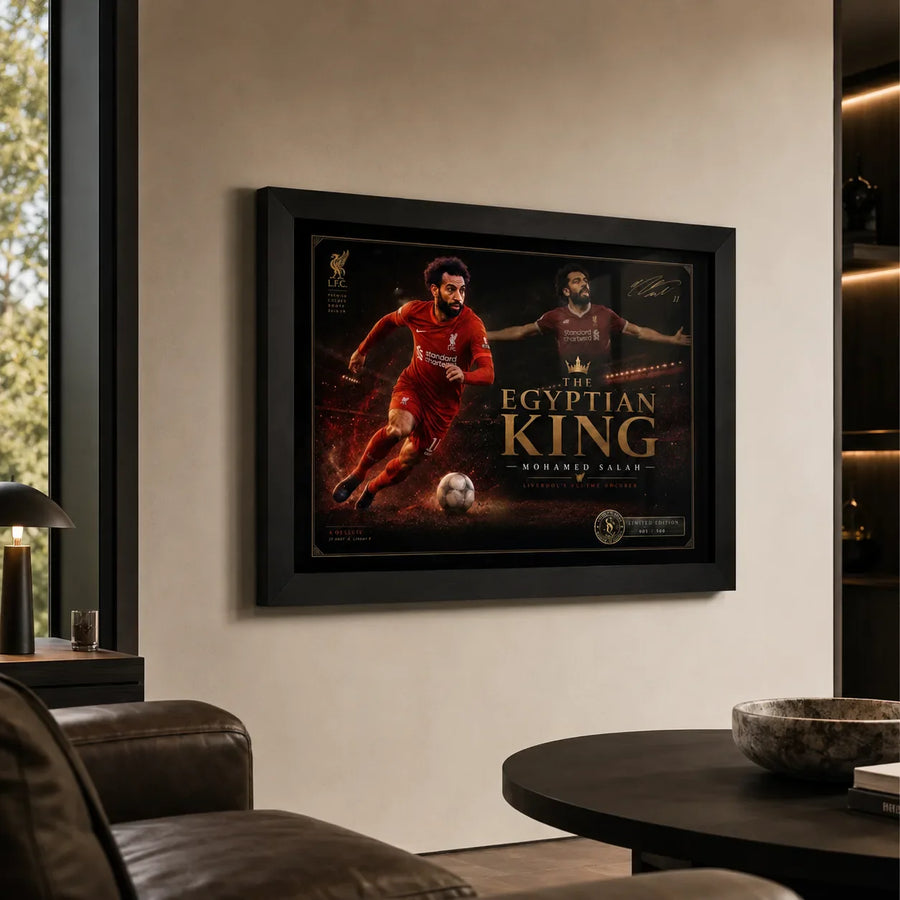 Black framed Mohamed Salah wall art displayed in a premium living room with warm neutral walls and leather seating.