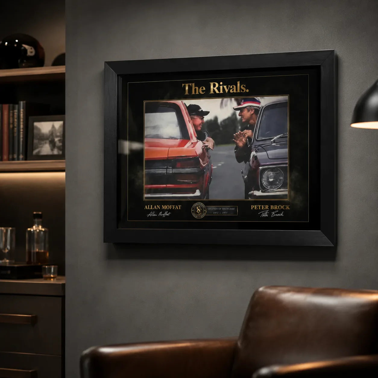 Black framed motorsport rivalry wall art styled in a dark man cave with collector display shelves