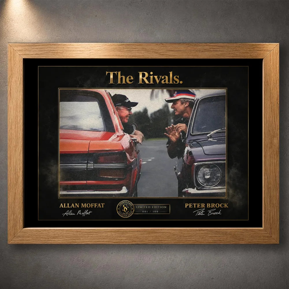 Motorsport rivalry wall art shown in an oak frame on a textured grey wall