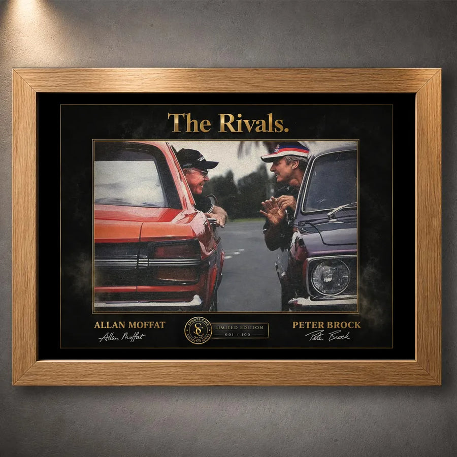 Motorsport rivalry wall art shown in an oak frame on a textured grey wall