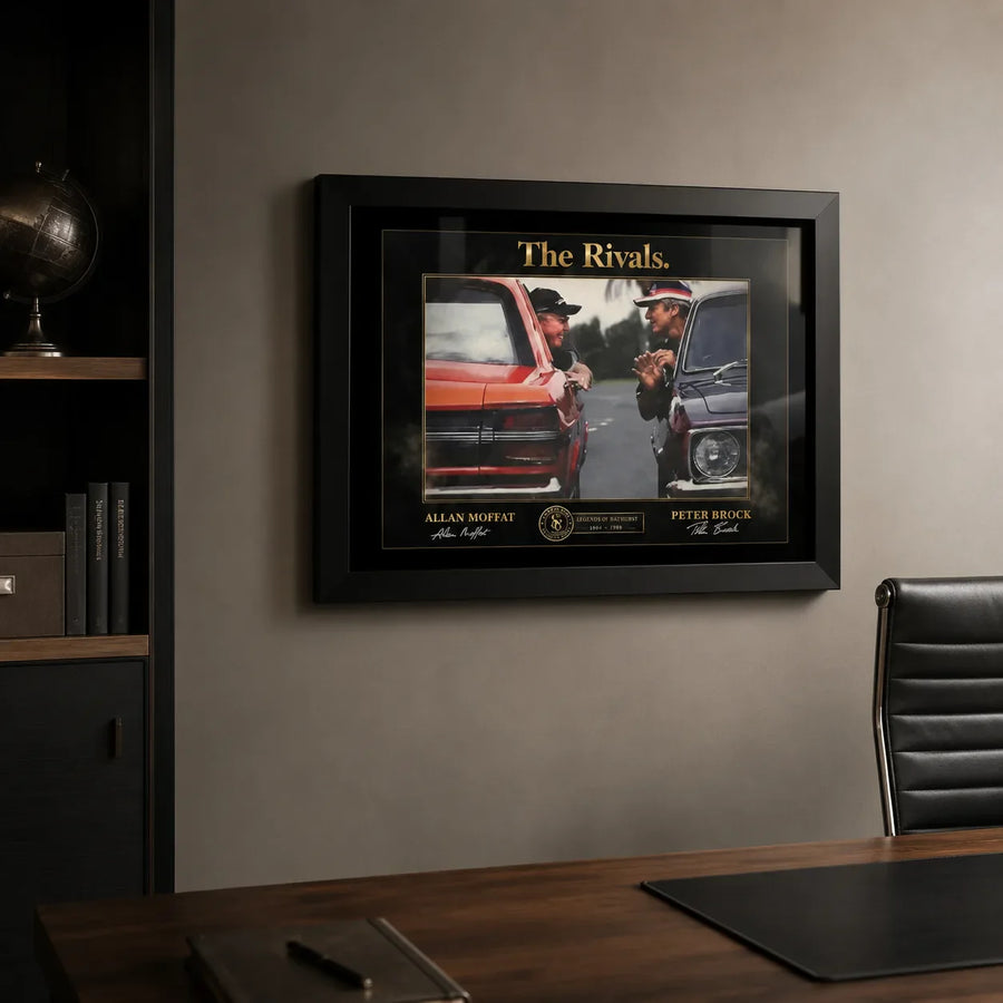 Framed motorsport rivalry wall art shown in a premium office with leather chair and dark shelving