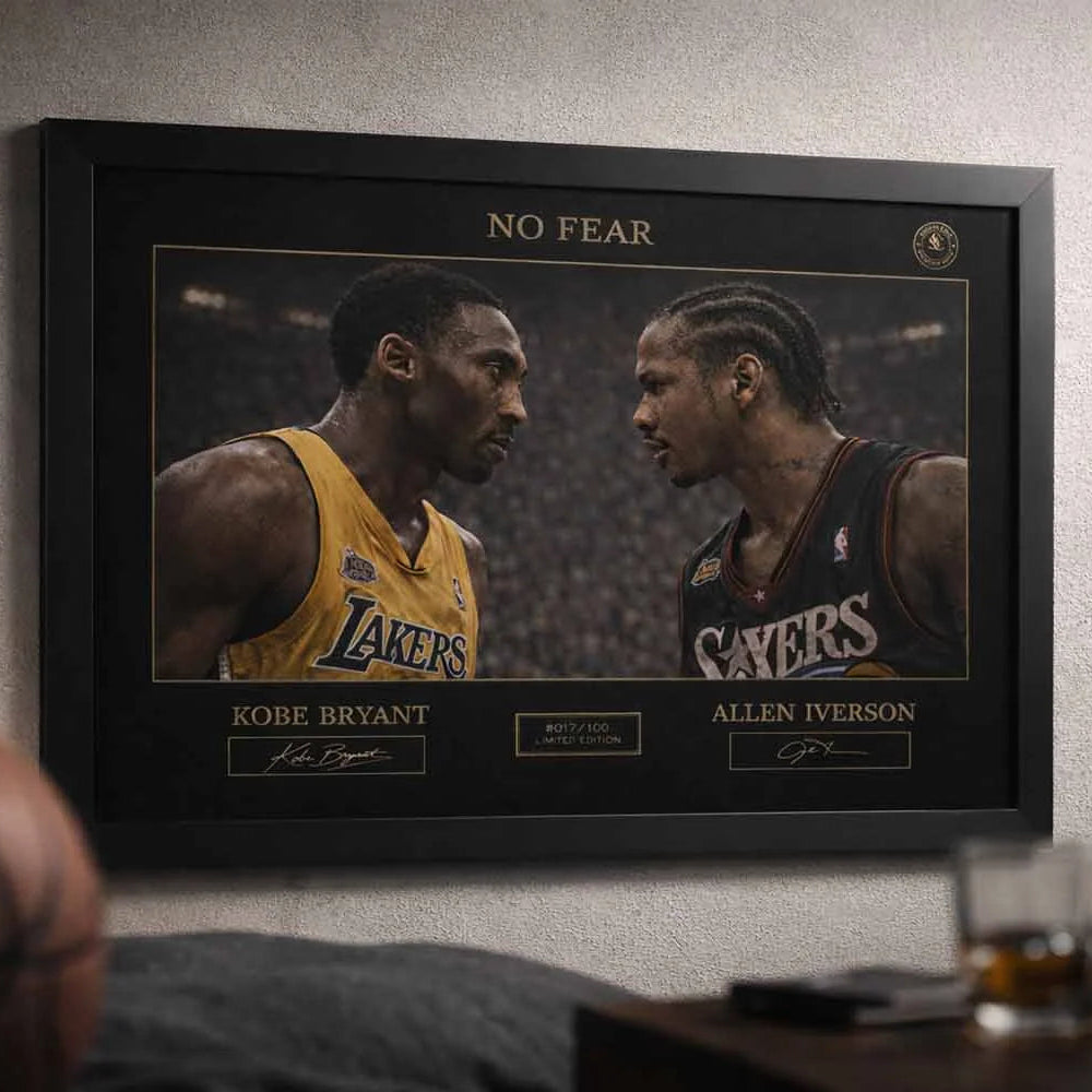 Black framed man cave wall décor showing Kobe Bryant vs Allen Iverson No Fear artwork styled in a modern sports lounge setting.