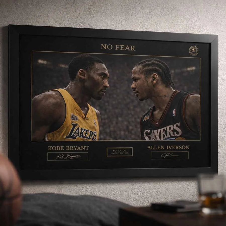 Black framed man cave wall décor showing Kobe Bryant vs Allen Iverson No Fear artwork styled in a modern sports lounge setting.