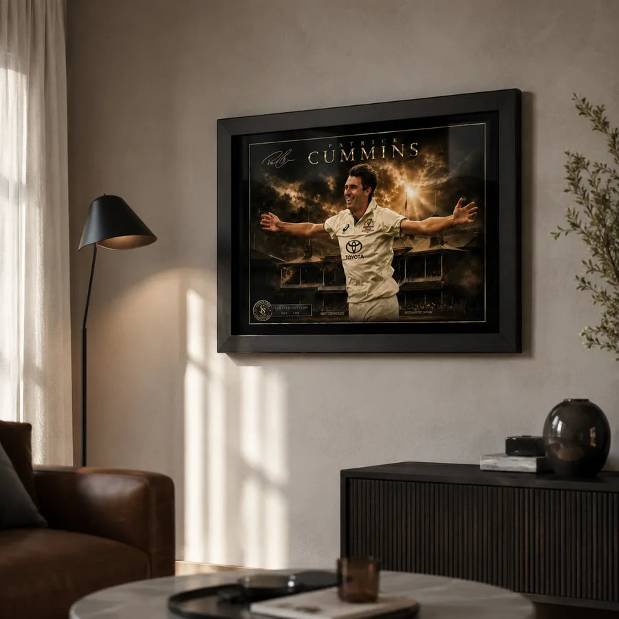 Pat Cummins cricket wall art in a black frame displayed in a warm modern living room with natural window light.