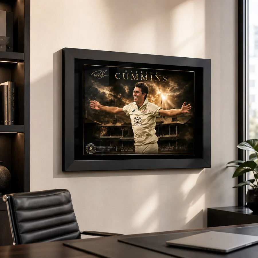 Pat Cummins black framed cricket wall art displayed in a modern home office above a desk and leather chair.