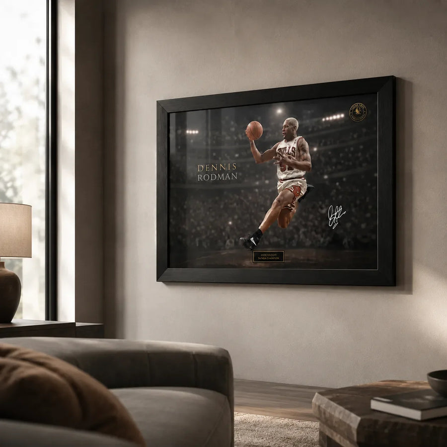 Dennis Rodman basketball wall art displayed in a black frame on a warm neutral living room wall.