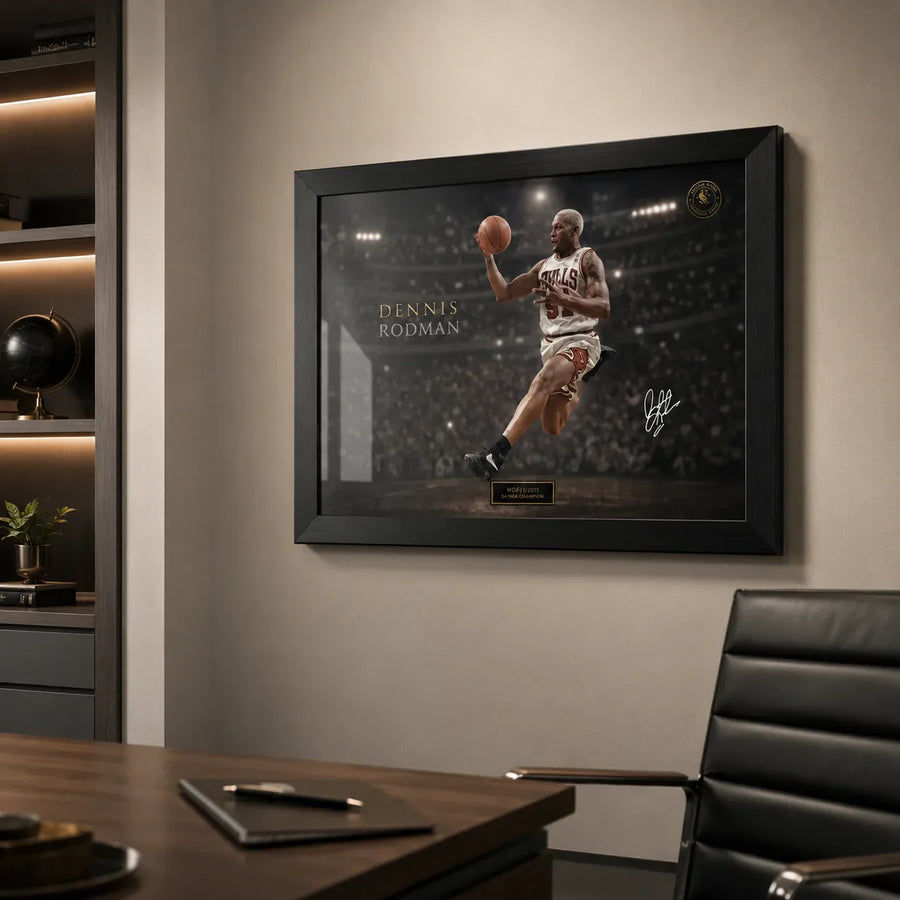 Dennis Rodman basketball wall art in a black frame mounted inside a modern office with timber desk and chair.