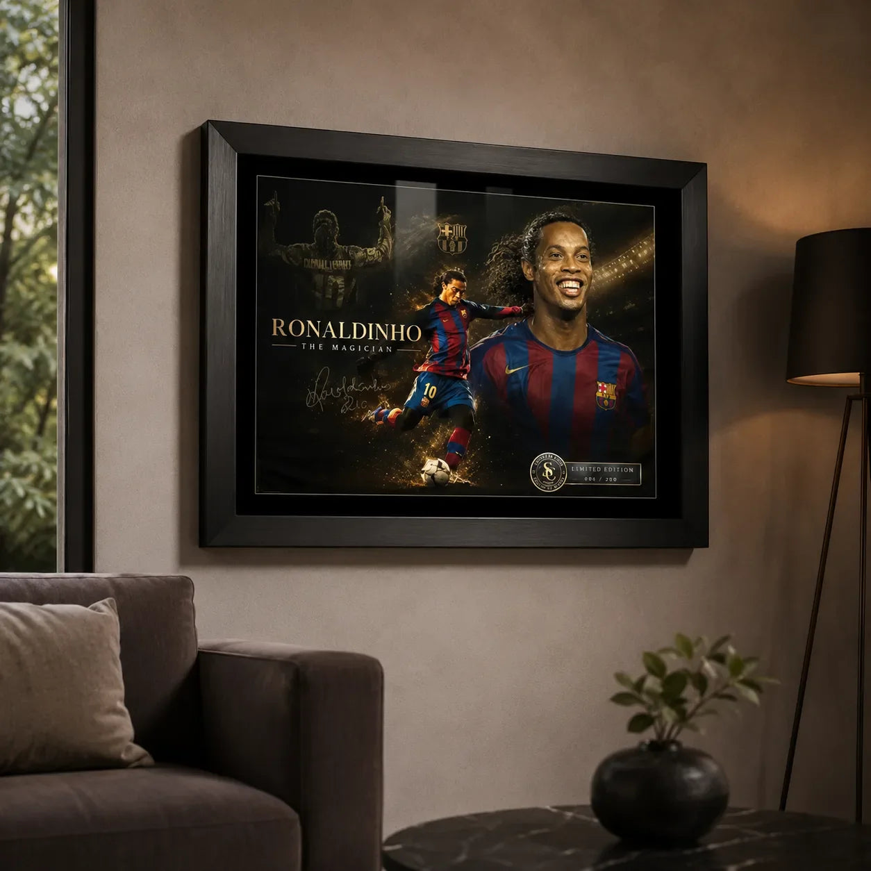 Framed Ronaldinho soccer wall art displayed on a living room wall above a sofa with warm interior lighting.