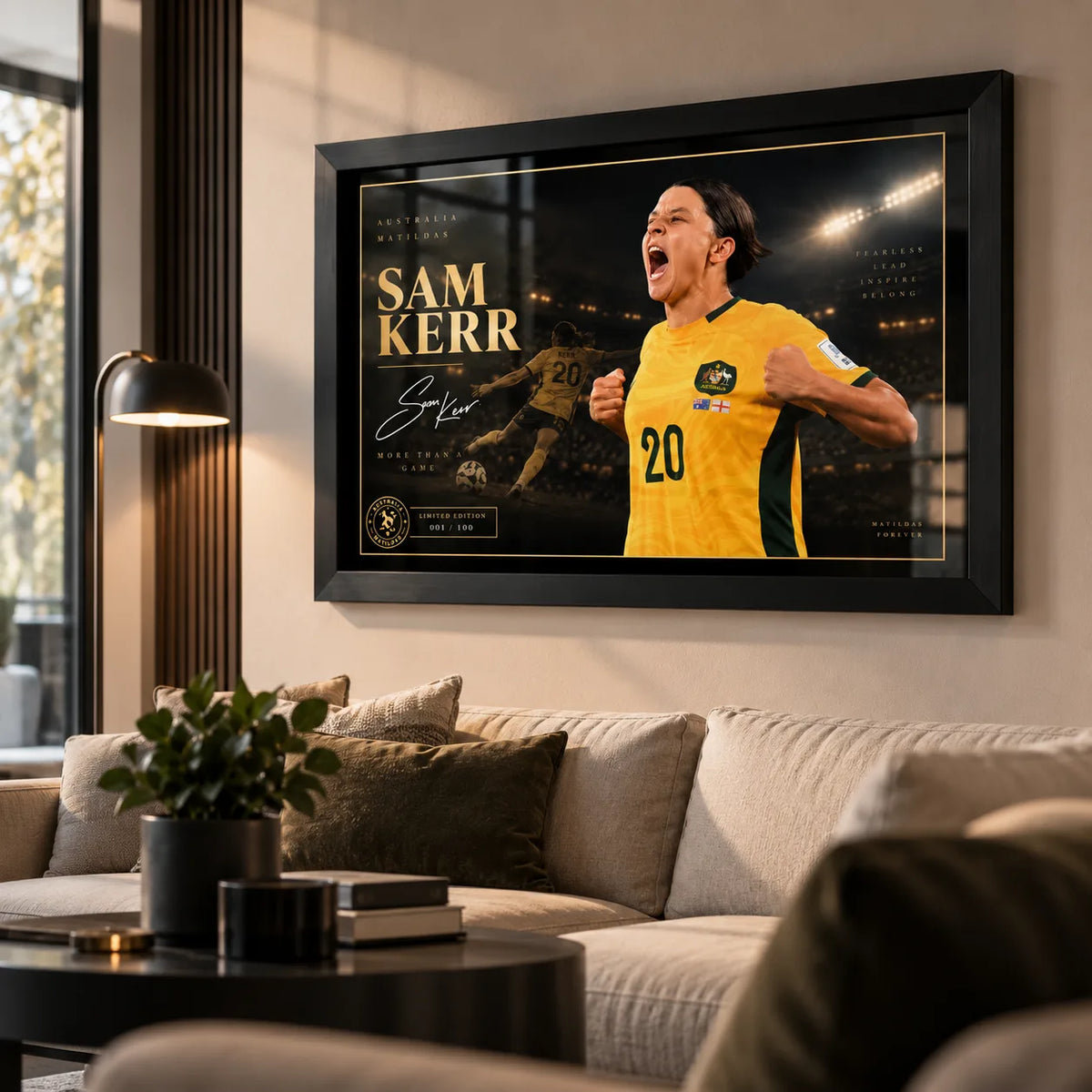Black framed Sam Kerr Matildas soccer wall art displayed in a bright modern living room above a neutral sofa.