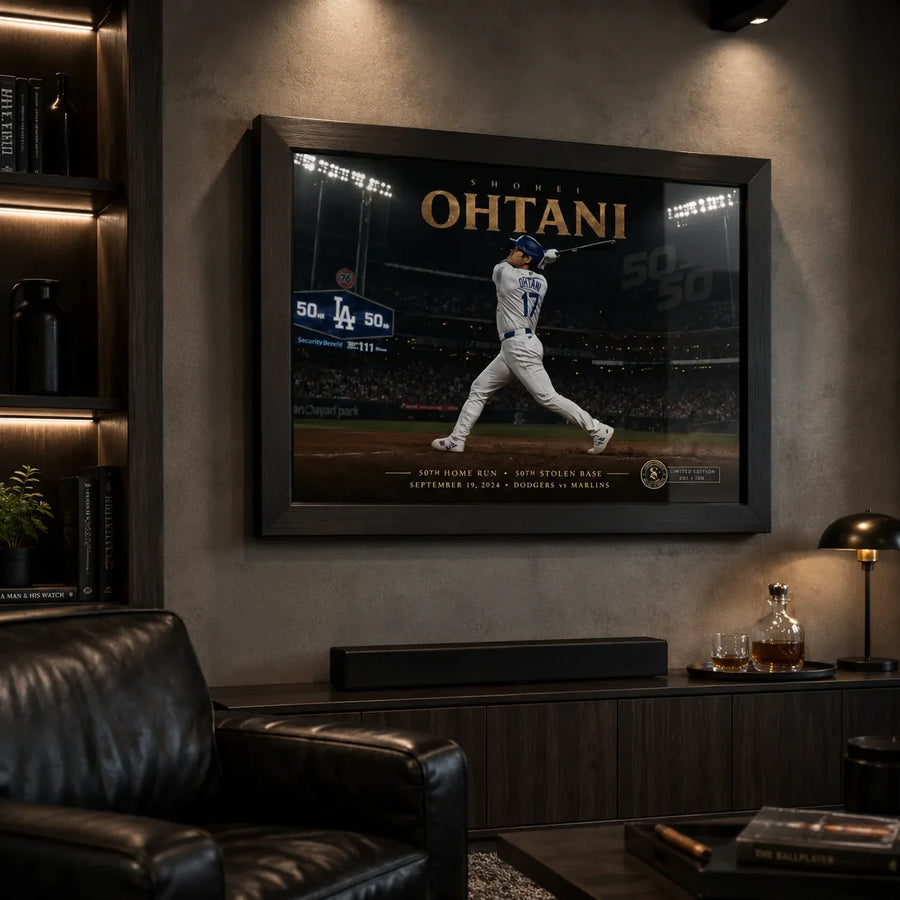 Shohei Ohtani framed baseball wall art displayed in a dark man cave with leather seating and warm display lighting.