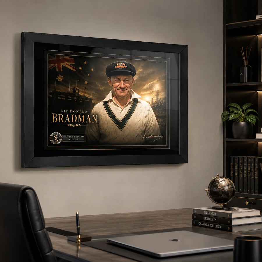 Sir Donald Bradman framed cricket wall art displayed above a refined office desk in a masculine study.