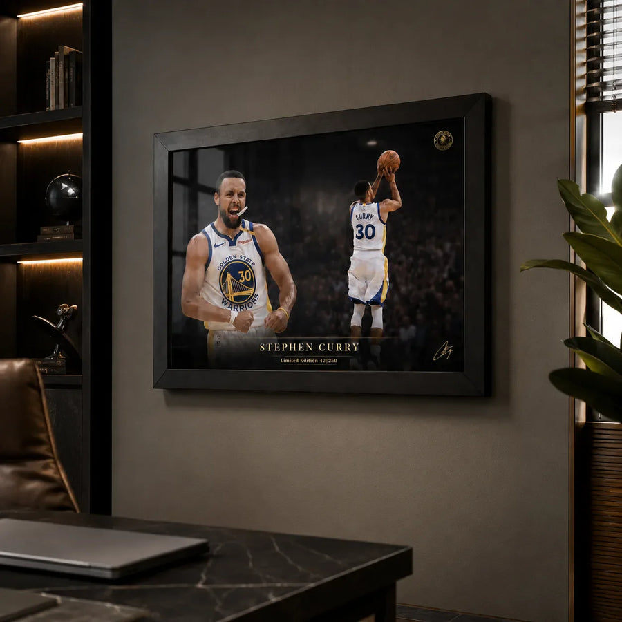 Black framed Stephen Curry wall art displayed in a moody office with shelving, desk, and window light.