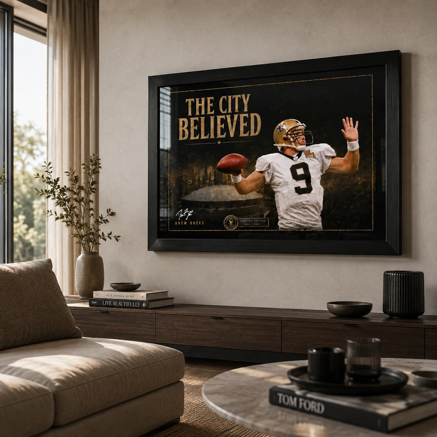 The City Believed NFL wall art displayed in a bright neutral living room with a black frame above a timber console.