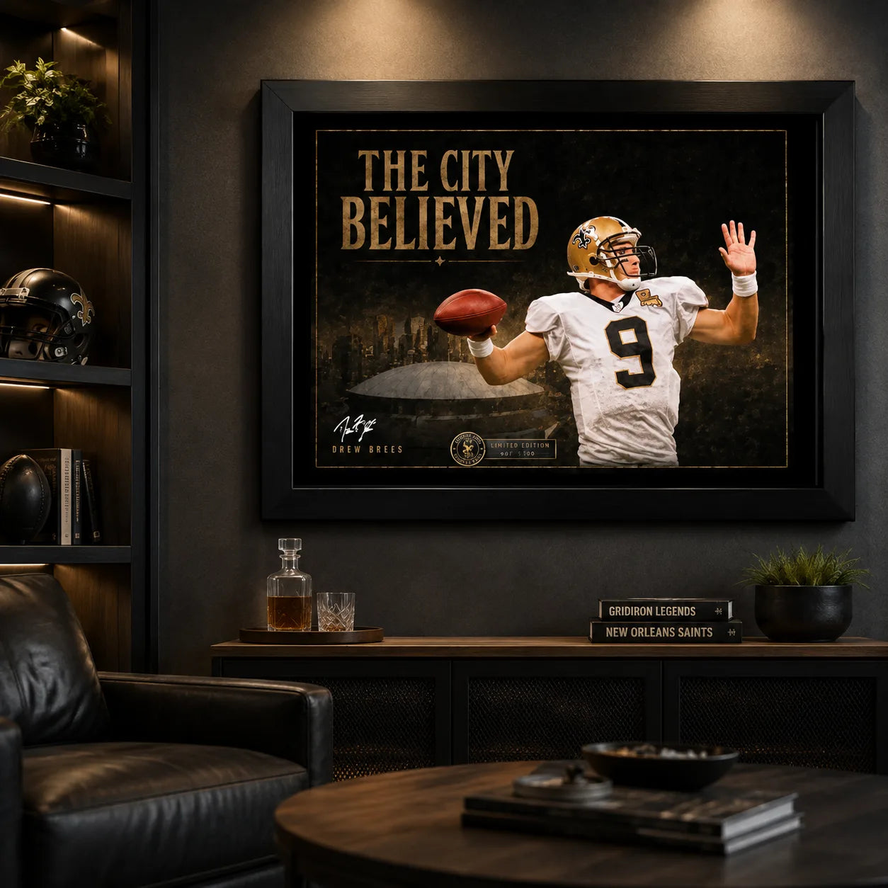 The City Believed New Orleans football wall art in a dark man cave, black framed above a cabinet with football memorabilia.