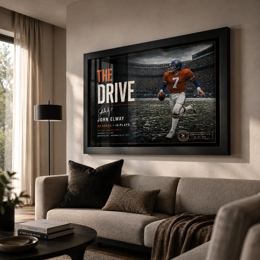 John Elway wall art displayed in a modern living room, showing The Drive collector piece in a black frame above a sofa.