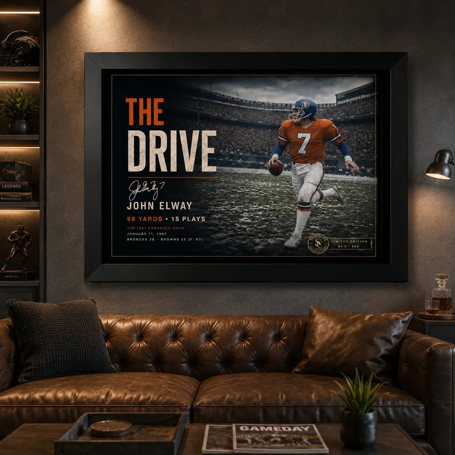 The Drive John Elway wall art in a dark man cave, black framed above a leather sofa with sports-inspired collector styling.