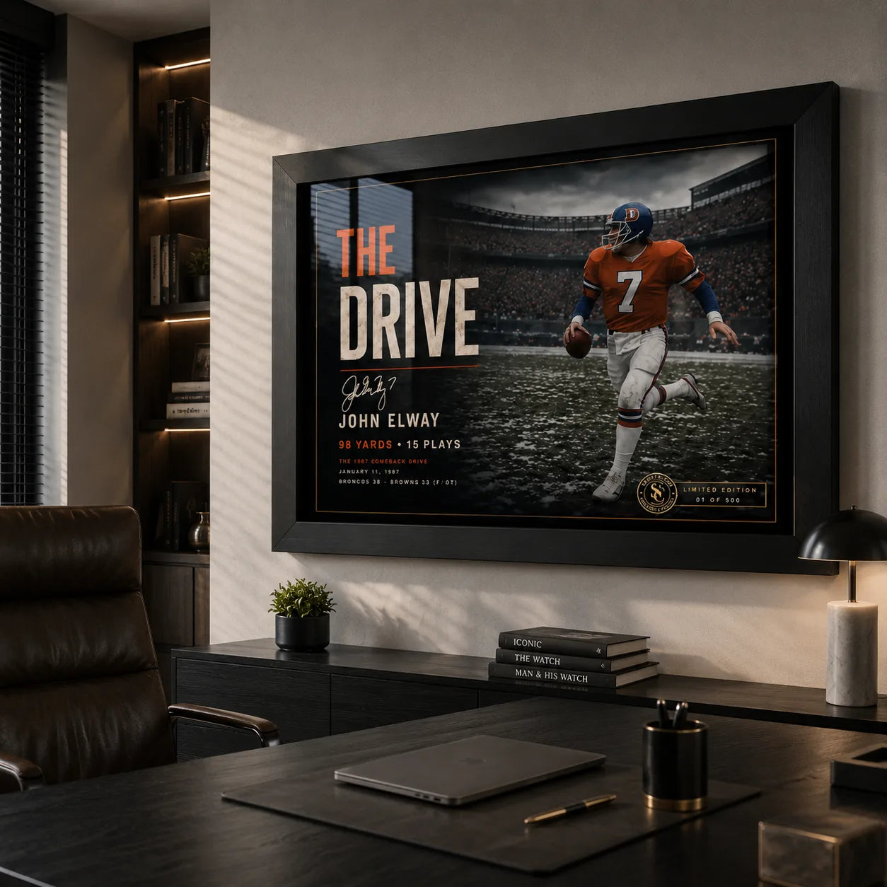 John Elway wall art displayed in a premium office, featuring The Drive in a black frame above a dark desk.