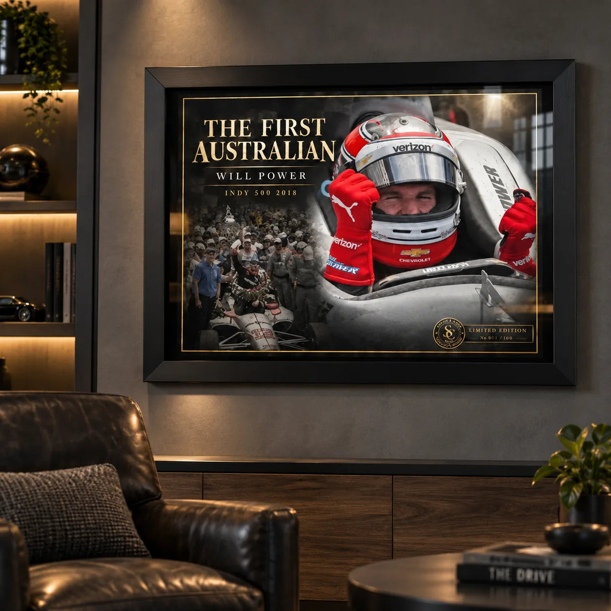 Will Power wall art displayed in a dark man cave with black frame, warm shelving lights and motorsport collector styling.