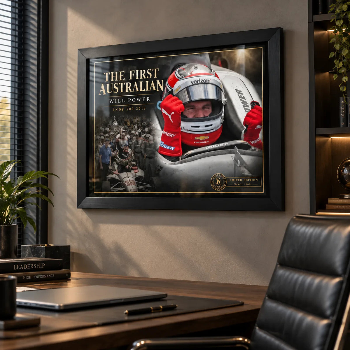Black framed Will Power wall art displayed above a modern office desk with warm light and dark wood furnishings.