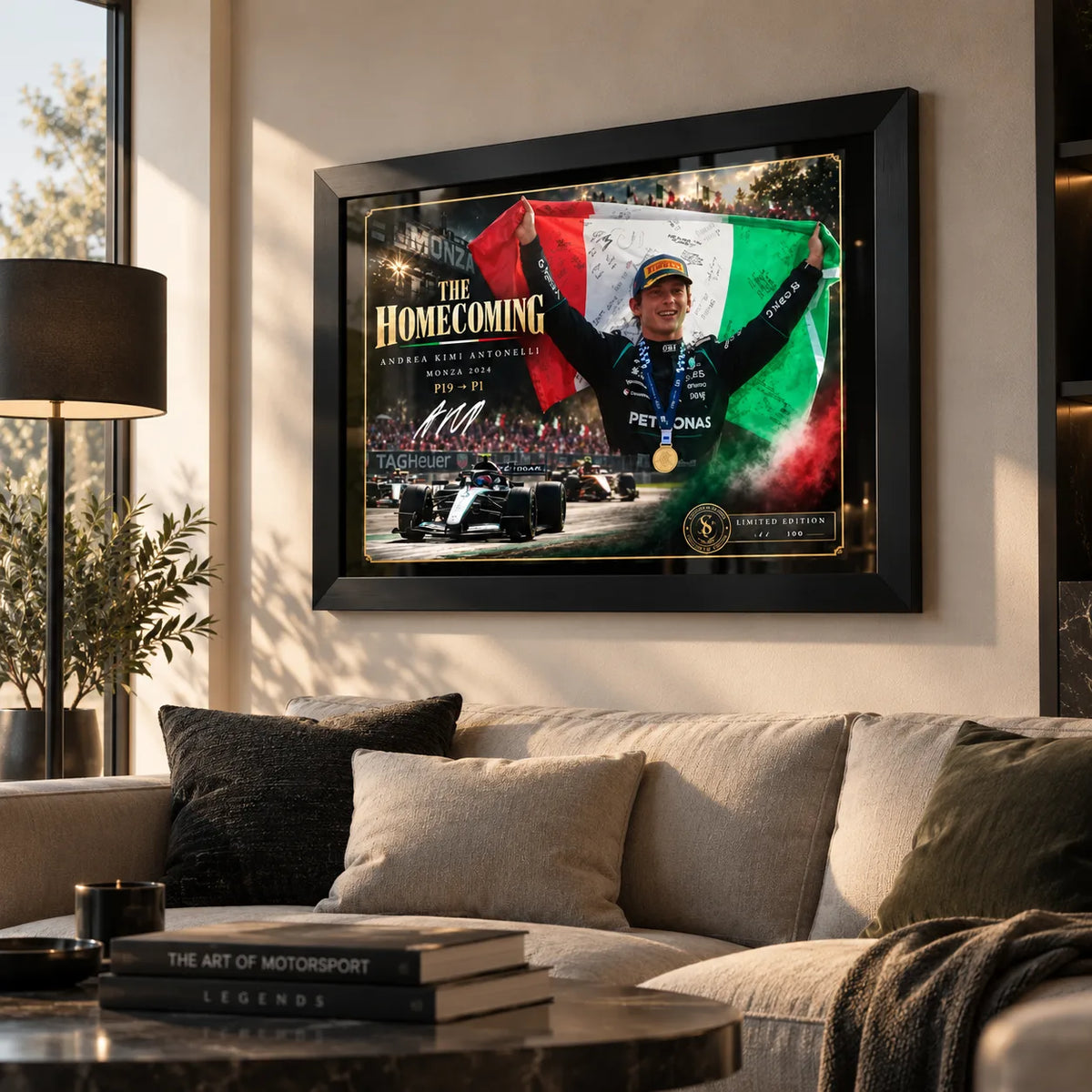 Andrea Kimi Antonelli wall art displayed above a sofa in a modern living room with a black frame and warm natural light.