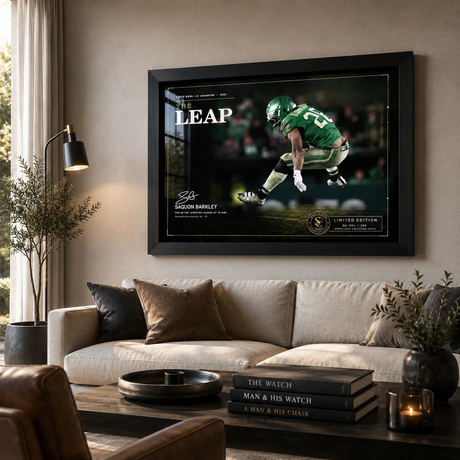 The Leap Saquon Barkley wall art displayed above a neutral living room sofa in a premium black frame.